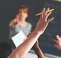 Student raising a hand in the classroom