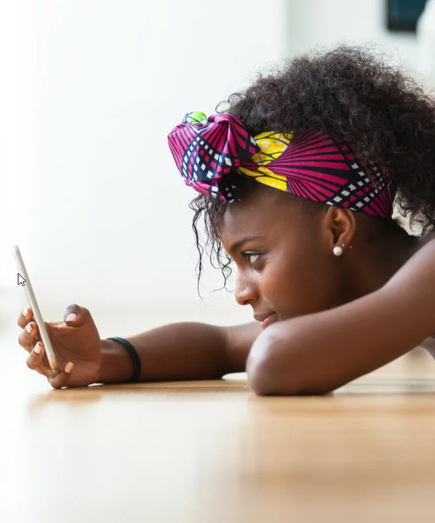 Student lying down and viewing an iphone 